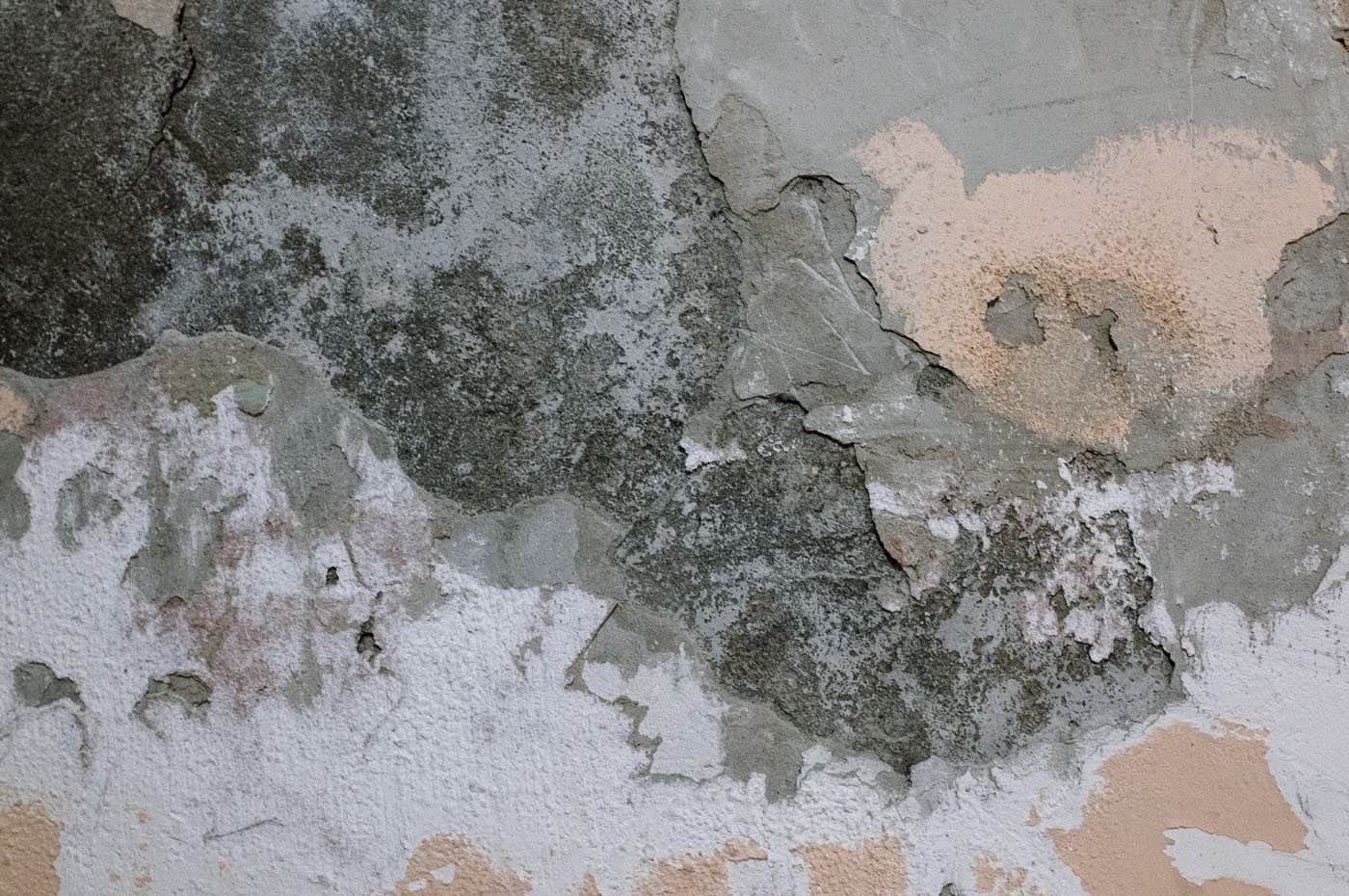 Muro con humedad y pintura desprendida por una fuga de agua oculta